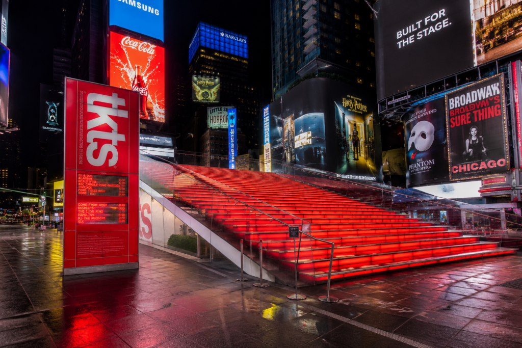 TKTS red bleacher steps at Times Square New York illuminated at night